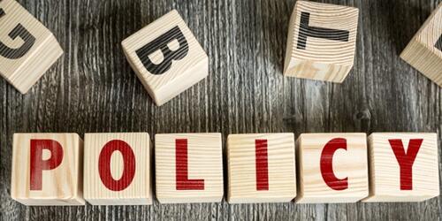 Word 'policy' spelled out in wooden blocks